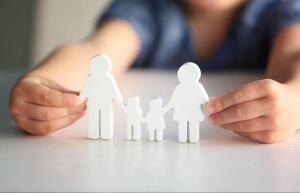 child playing with paper family